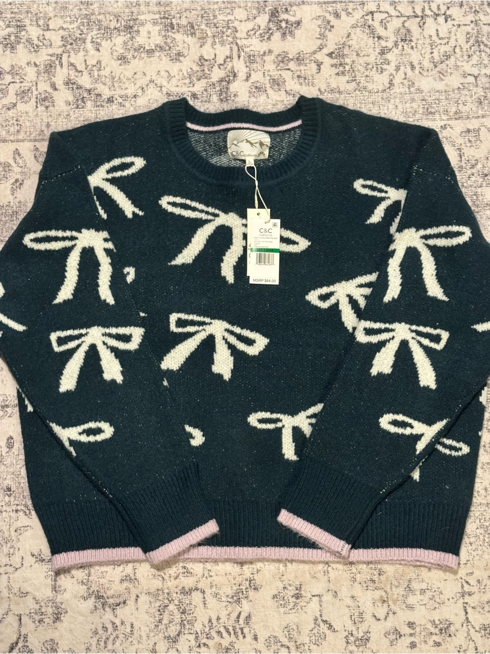 Hunter green sweater with bows and pink trim